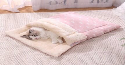 Cat sleeping comfortably inside a soft plush winter sleeping bag